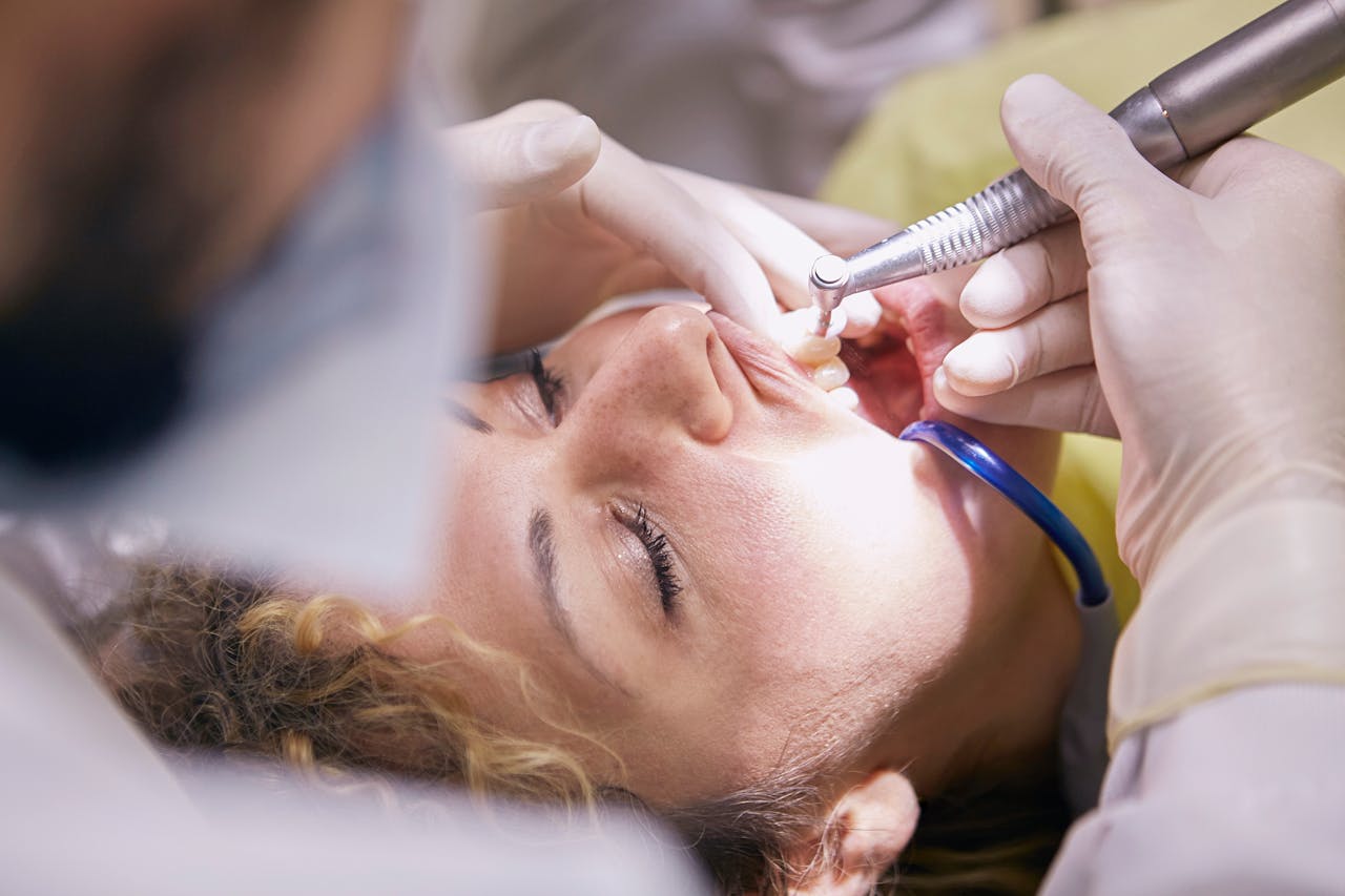 Close-up of a dental procedure with dentist and patient in a clinic setting.