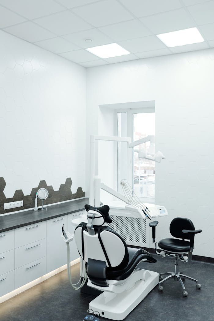 A bright, clean dental clinic showcasing a modern dental chair and equipment.